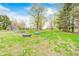 Spacious backyard featuring mature trees, green lawn, and an outbuilding at 5541 S County Road 150 E, Clayton, IN 46118