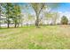 Sprawling backyard featuring a lush green lawn and mature trees at 5541 S County Road 150 E, Clayton, IN 46118