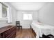 Bright bedroom featuring wood floors, single bed, dresser, and windows with natural light at 5541 S County Road 150 E, Clayton, IN 46118