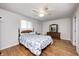 Cozy bedroom with hardwood floors, a ceiling fan, and a large window at 5541 S County Road 150 E, Clayton, IN 46118