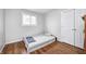 Neutral bedroom featuring a single bed, wood floor, a window, and a closet at 5541 S County Road 150 E, Clayton, IN 46118