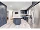 Modern kitchen with stainless steel appliances, granite countertops, a center island, and ample cabinet space at 5541 S County Road 150 E, Clayton, IN 46118