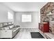 Cozy living room featuring a decorative brick accent wall, fireplace, and comfortable couch at 5541 S County Road 150 E, Clayton, IN 46118