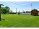 Large backyard with a storage shed and a well-maintained lawn, perfect for outdoor activities at 5693 W Walnut St, Greenwood, IN 46142