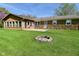 Expansive backyard features a fire pit and stone accents on the home's exterior at 5693 W Walnut St, Greenwood, IN 46142