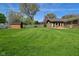 Spacious backyard featuring well-manicured lawn, a fire pit, and a storage shed at 5693 W Walnut St, Greenwood, IN 46142