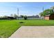Spacious backyard with a well-maintained lawn, fire pit, and perimeter fencing at 5693 W Walnut St, Greenwood, IN 46142