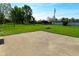 Large backyard with a concrete patio, green grass, a fire pit, and a shed at 5693 W Walnut St, Greenwood, IN 46142