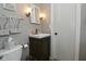 Cozy bathroom with updated vanity, framed mirror, modern fixtures, and door to the laundry at 5693 W Walnut St, Greenwood, IN 46142