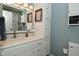 Bathroom showcasing white cabinetry, a large mirror, and a coordinated shower curtain at 5693 W Walnut St, Greenwood, IN 46142