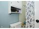 Bathroom with white toilet, cabinet and shower curtain with avian them and organized storage at 5693 W Walnut St, Greenwood, IN 46142