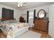 Bedroom with a wooden bed and dresser, ceiling fan and a comfy rug creating a cozy space at 5693 W Walnut St, Greenwood, IN 46142