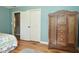 Bedroom featuring a bed and wooden wardrobe with storage and a glimpse of the doorway to other rooms at 5693 W Walnut St, Greenwood, IN 46142