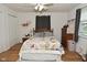 Bedroom featuring hardwood floors, a bed, a ceiling fan and organized storage solutions and a window at 5693 W Walnut St, Greenwood, IN 46142