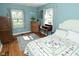 Bedroom with a bed, desk, dresser, and a soft gray rug creating a cozy and inviting space at 5693 W Walnut St, Greenwood, IN 46142