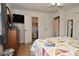 Bright bedroom featuring a TV, wood floors, and adjoining bathroom at 5693 W Walnut St, Greenwood, IN 46142