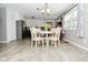 Cozy dining area adjacent to kitchen with table and chairs bathed in natural light from nearby window at 5693 W Walnut St, Greenwood, IN 46142