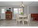 Bright dining area with tile floors, table and chairs, and large window at 5693 W Walnut St, Greenwood, IN 46142