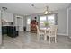 Bright dining area with tile floors, modern light fixture, and large window at 5693 W Walnut St, Greenwood, IN 46142