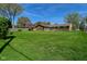 Expansive green backyard view with charming single-story home at 5693 W Walnut St, Greenwood, IN 46142