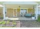 Inviting covered front porch with stone accents, seating area, and decorative plants at 5693 W Walnut St, Greenwood, IN 46142