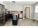 Modern kitchen with stainless steel appliances, island, stylish backsplash, and white and black cabinets at 5693 W Walnut St, Greenwood, IN 46142