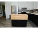 Bright kitchen featuring stainless steel appliances, stylish backsplash, black lower cabinets and white upper cabinets at 5693 W Walnut St, Greenwood, IN 46142