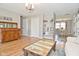 Open living room showcasing hardwood floors, neutral decor, and a view to the dining area at 5693 W Walnut St, Greenwood, IN 46142