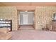 Living room with a stone wall and a doorway leading to another room at 5693 W Walnut St, Greenwood, IN 46142