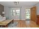 Open living room featuring hardwood floors, neutral decor, and view of the front yard at 5693 W Walnut St, Greenwood, IN 46142