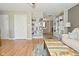 Stylish living room showcasing hardwood floors, built-in shelves, and a view to the dining area at 5693 W Walnut St, Greenwood, IN 46142