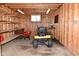 Inside the shed featuring wood paneling, shelving, and yard equipment at 5693 W Walnut St, Greenwood, IN 46142