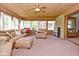 Comfortable sunroom with plenty of natural light features desk and bookcase at 5693 W Walnut St, Greenwood, IN 46142
