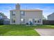 Backyard featuring a well-maintained lawn, patio, and two-story home exterior at 5886 N Peppereel Way, McCordsville, IN 46055