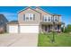 Charming two-story home with three-car garage and well-maintained lawn in a suburban neighborhood at 5886 N Peppereel Way, McCordsville, IN 46055