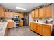Functional kitchen with wooden cabinetry, stainless steel appliances, and ample counter space at 5886 N Peppereel Way, McCordsville, IN 46055