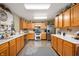 Bright kitchen featuring wood cabinets, stainless steel appliances, and an open design at 5886 N Peppereel Way, McCordsville, IN 46055
