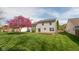 Spacious backyard featuring a wood deck and a beautifully blossoming tree at 6075 Bristlecone Dr, Fishers, IN 46038