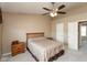 Neutral bedroom featuring a ceiling fan, bedside table, and natural light at 6075 Bristlecone Dr, Fishers, IN 46038