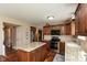 Well-equipped kitchen with a granite island, dark wood cabinets, stainless steel appliances, and hardwood floors at 6075 Bristlecone Dr, Fishers, IN 46038