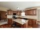 Modern kitchen featuring granite countertops, dark cabinets, and stainless steel appliances at 6075 Bristlecone Dr, Fishers, IN 46038