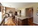 Open kitchen with granite island and floors offering seamless flow to the living area with a cozy fireplace at 6075 Bristlecone Dr, Fishers, IN 46038