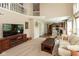 Spacious living room featuring hardwood floors, a cozy fireplace, and an open floor plan at 6075 Bristlecone Dr, Fishers, IN 46038