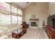 Bright living room featuring large windows, a cozy fireplace, comfortable seating, and plenty of natural light at 6075 Bristlecone Dr, Fishers, IN 46038