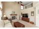 Bright living room featuring high ceilings, a cozy fireplace, and a comfortable seating area at 6075 Bristlecone Dr, Fishers, IN 46038