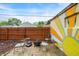 A backyard featuring a fire pit with chairs surrounding a mural on an exterior wall at 6106 Evanston Ave, Indianapolis, IN 46220