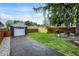 A spacious backyard includes a grill, dining table, and colorful mural adding charm to the property at 6106 Evanston Ave, Indianapolis, IN 46220