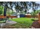 A spacious backyard featuring a patio dining set, grill, and a well-maintained lawn at 6106 Evanston Ave, Indianapolis, IN 46220