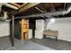 Unfinished basement with exposed beams, a laundry area, and utility shelving for storage at 6106 Evanston Ave, Indianapolis, IN 46220