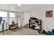 Basement area showcasing a neat clothing rack, small display shelf, window and a full-length mirror at 6106 Evanston Ave, Indianapolis, IN 46220